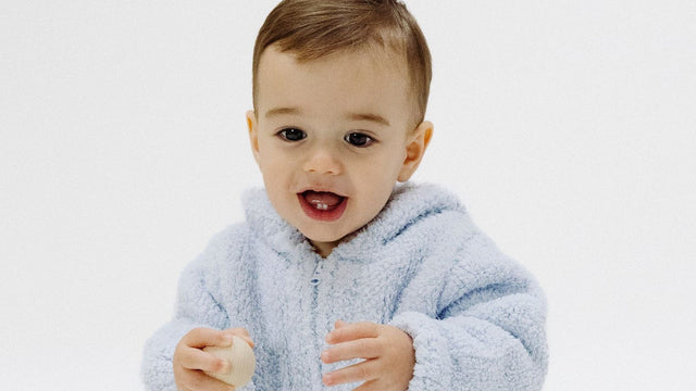 Baby wearing a soft blue fleece sweater