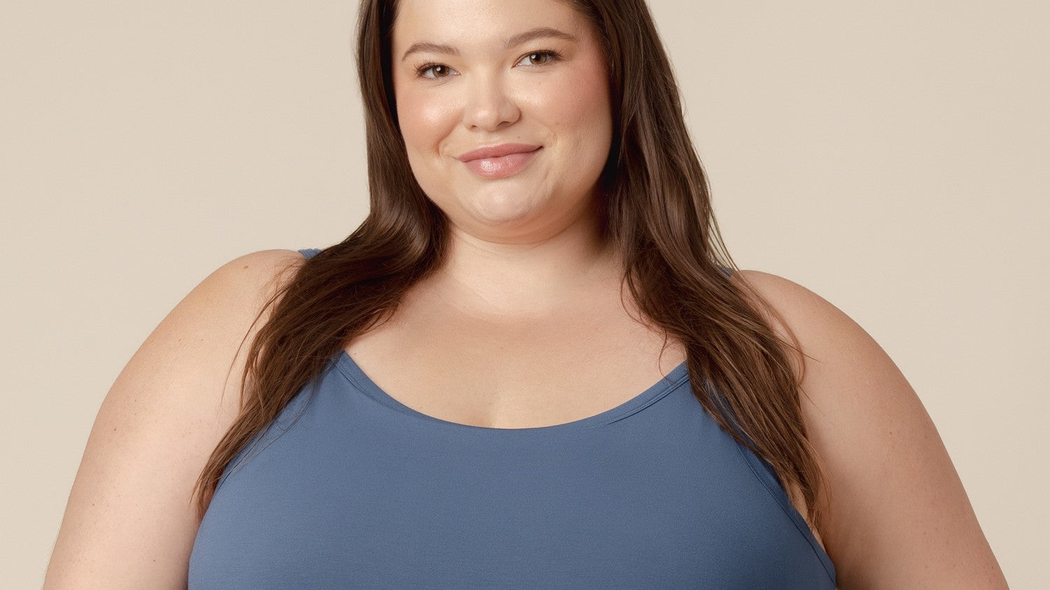 Smiling mom wearing a comfortable slate-blue nursing tank