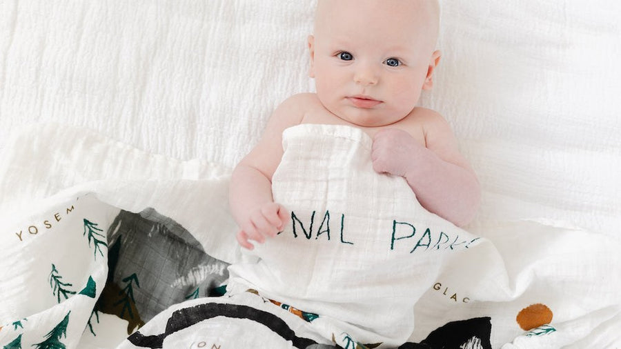 Baby swaddled in a printed muslin sleep sack