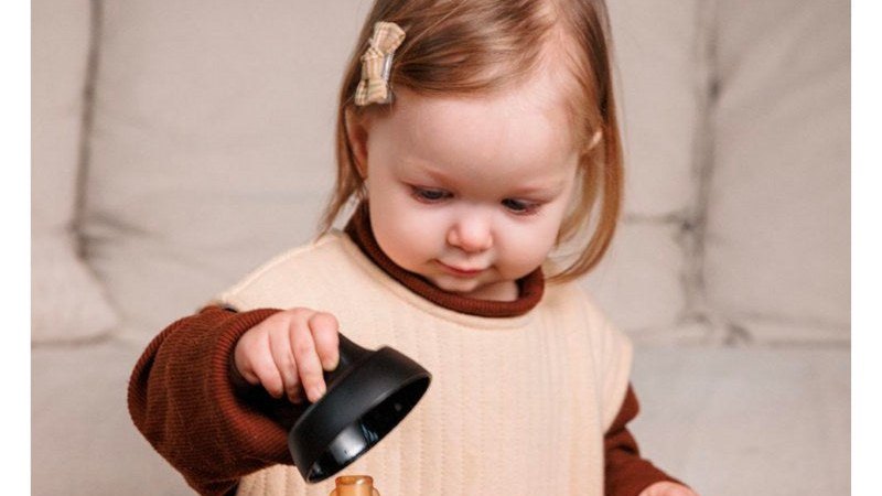 Toddler holding a baby bottle
