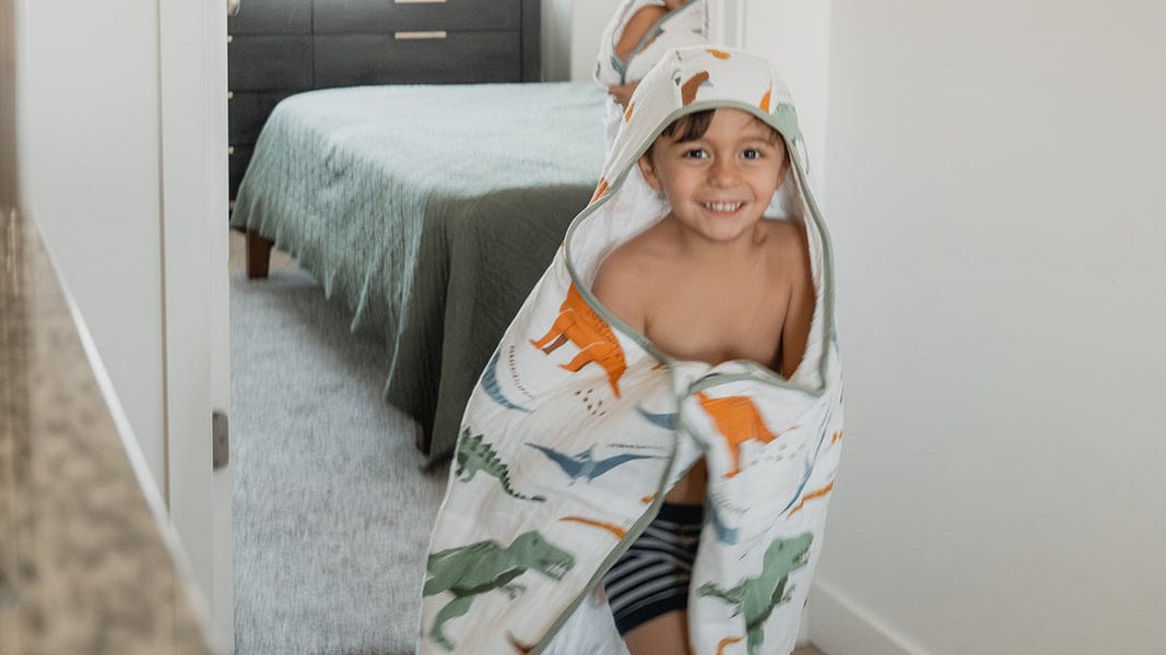 Child wrapped in a hooded baby towel