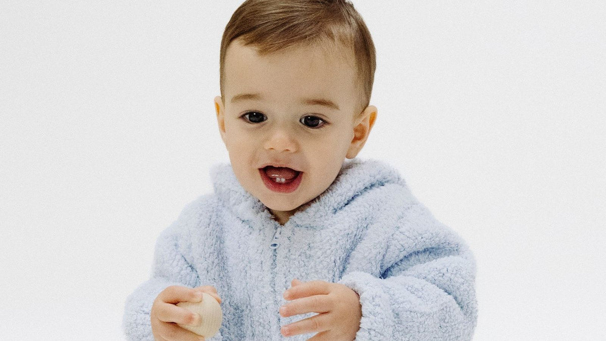 Baby wearing a soft blue fleece sweater