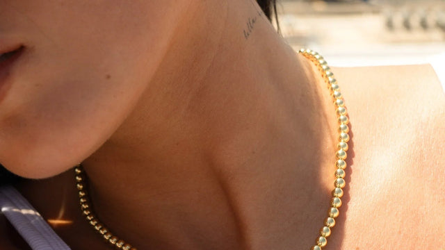 Woman wearing a delicate gold necklace