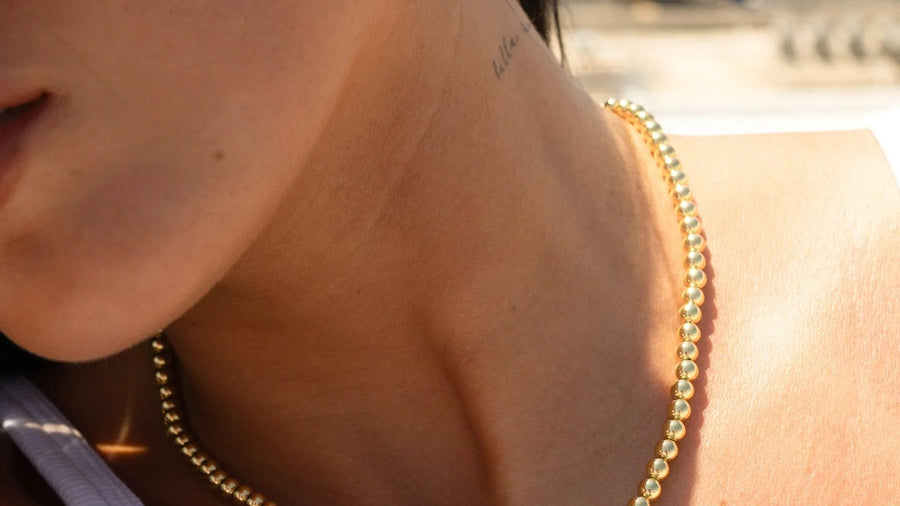 Woman wearing a delicate gold necklace