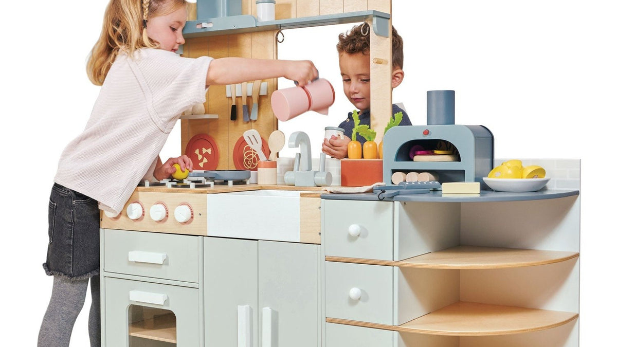 Child playing at a play kitchen