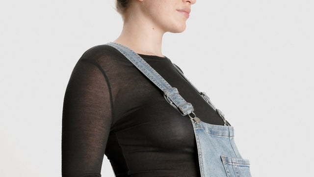 Pregnant woman in overalls