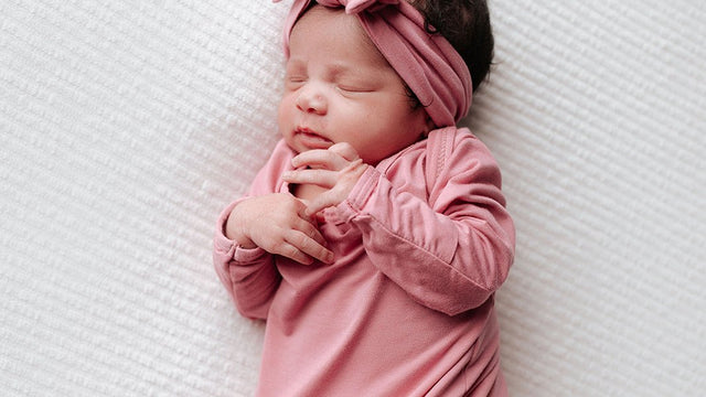 Newborn baby with a bow