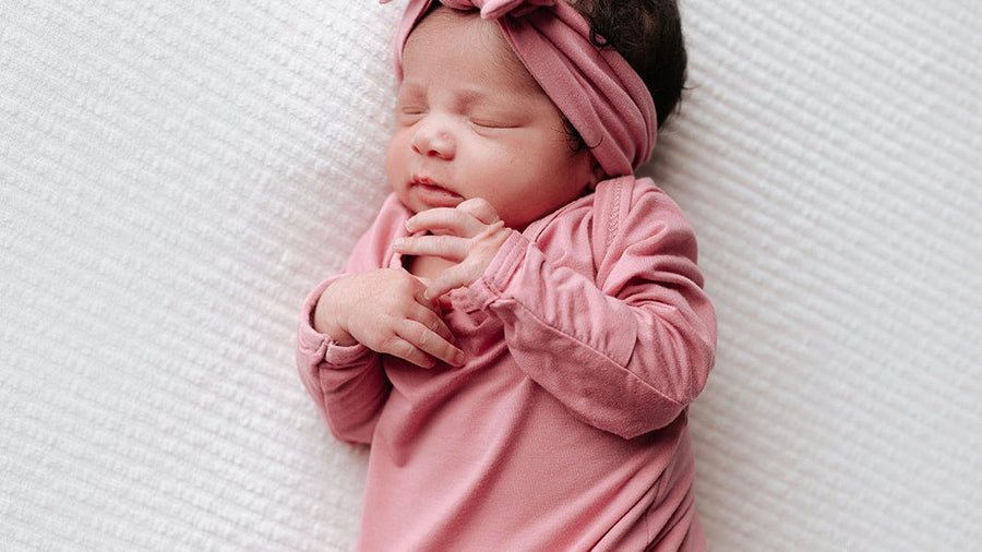 Newborn baby with a bow