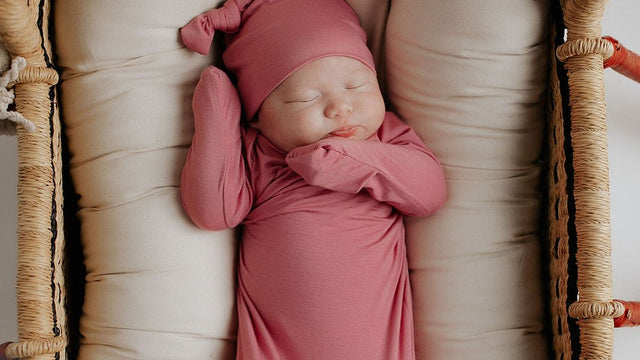 Sleeping newborn in a bassinet