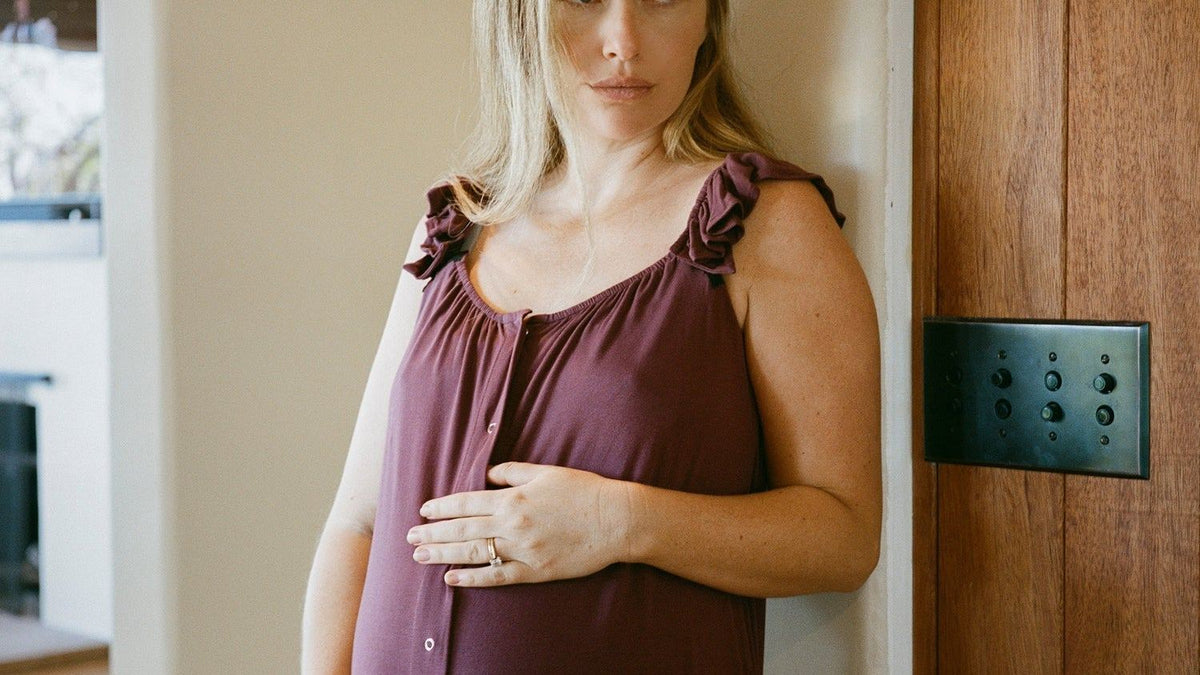 Pregnant woman resting a hand on her belly