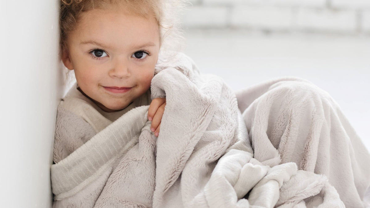 Toddler snuggled in a gray Saranoni Lush blanket — Saranoni blanket review