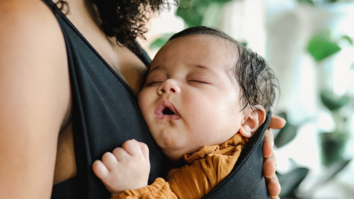 New mother babywearing her newborn