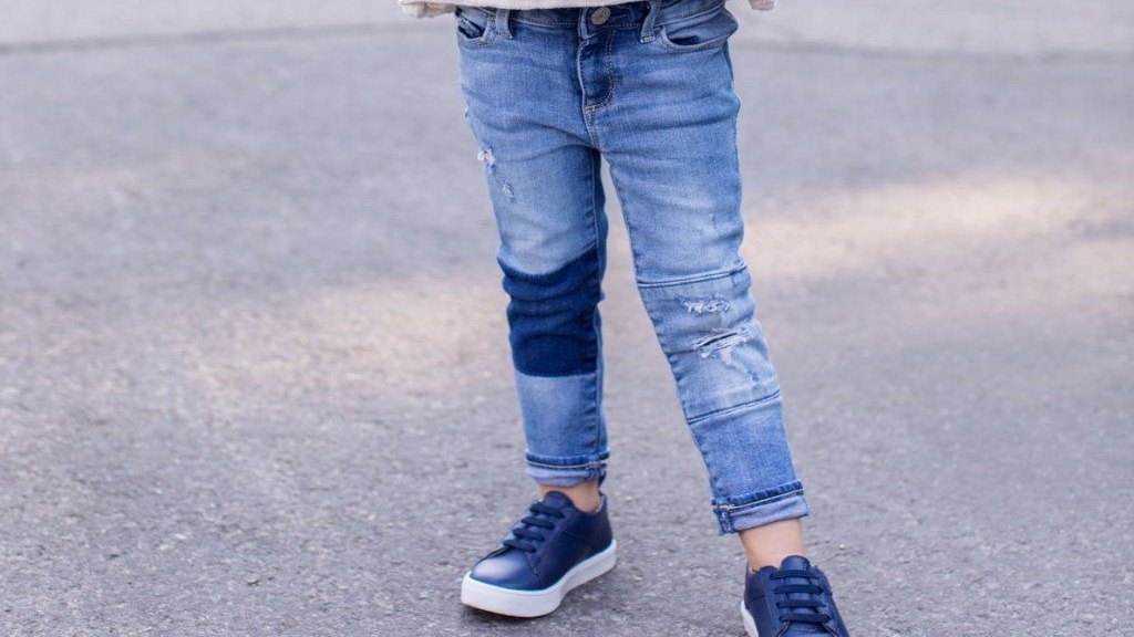 Child wearing lace-up sneakers