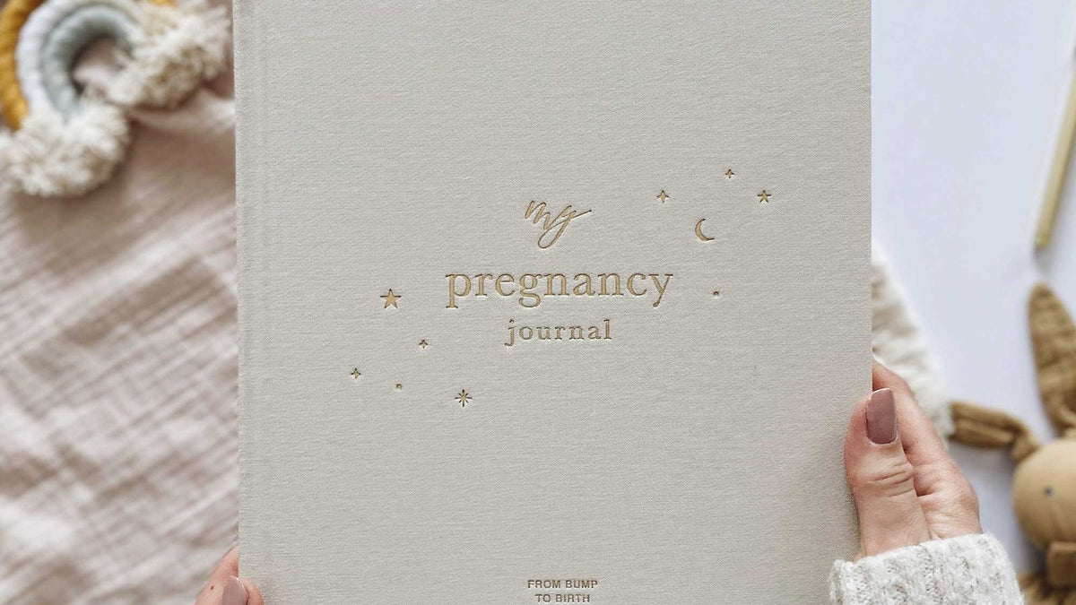 Expectant mother holding a pregnancy journal