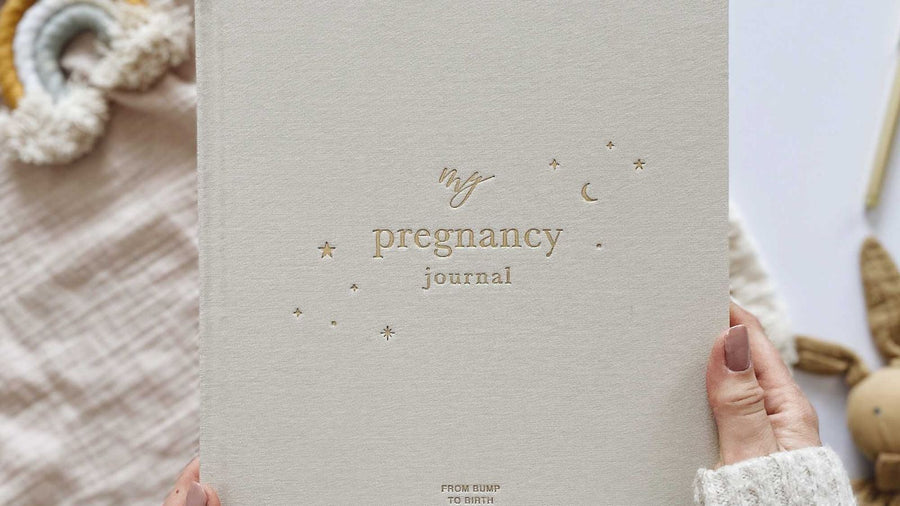 Expectant mother holding a pregnancy journal