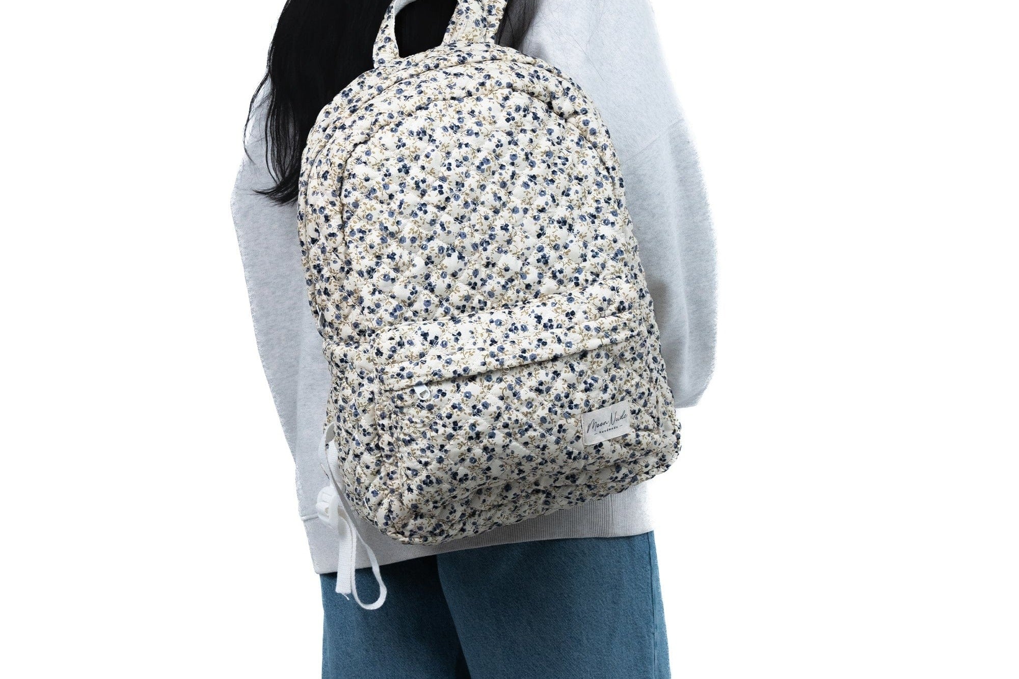 Child wearing a floral backpack