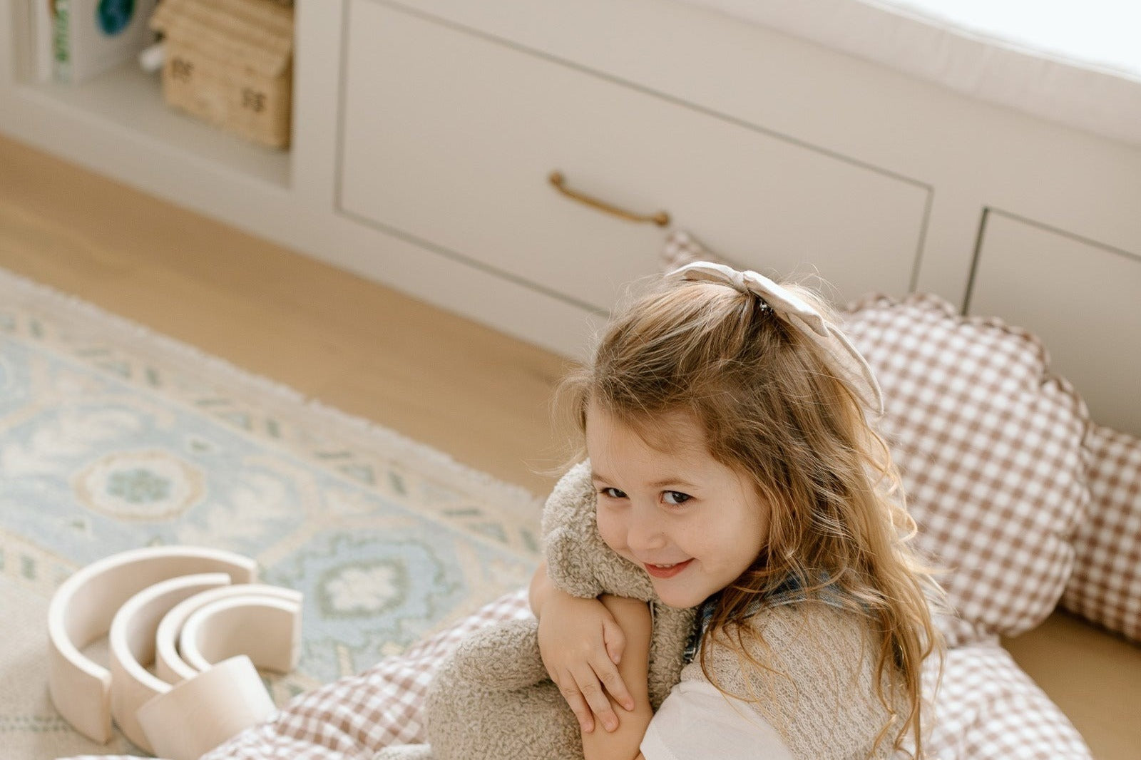 Girl on a gingham nap mat