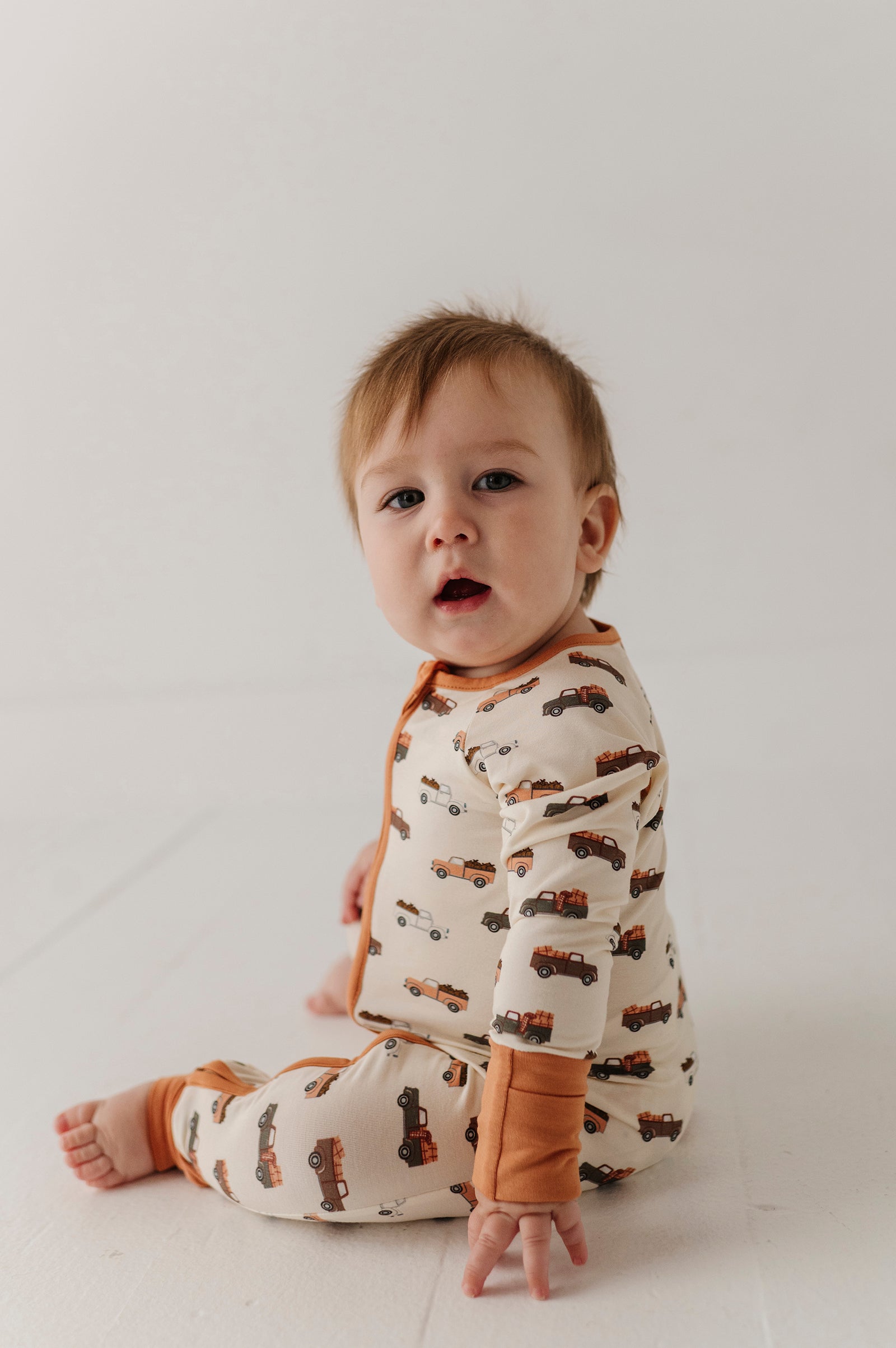 Baby Boy Long Sleeve Zip Romper In Pumpkin Trucks