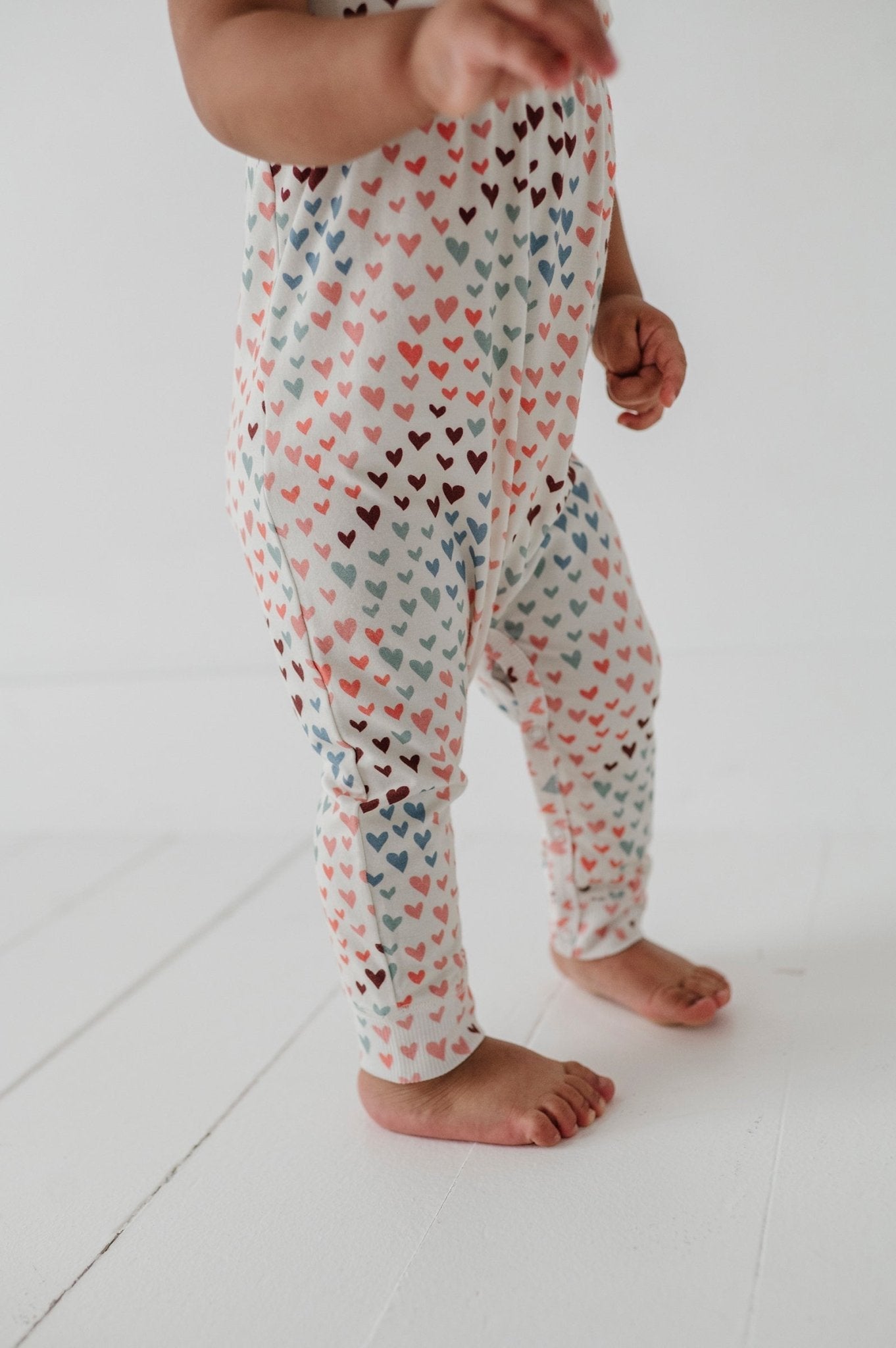 Baby Girl Short Sleeve Pant Romper In Rainbow Hearts