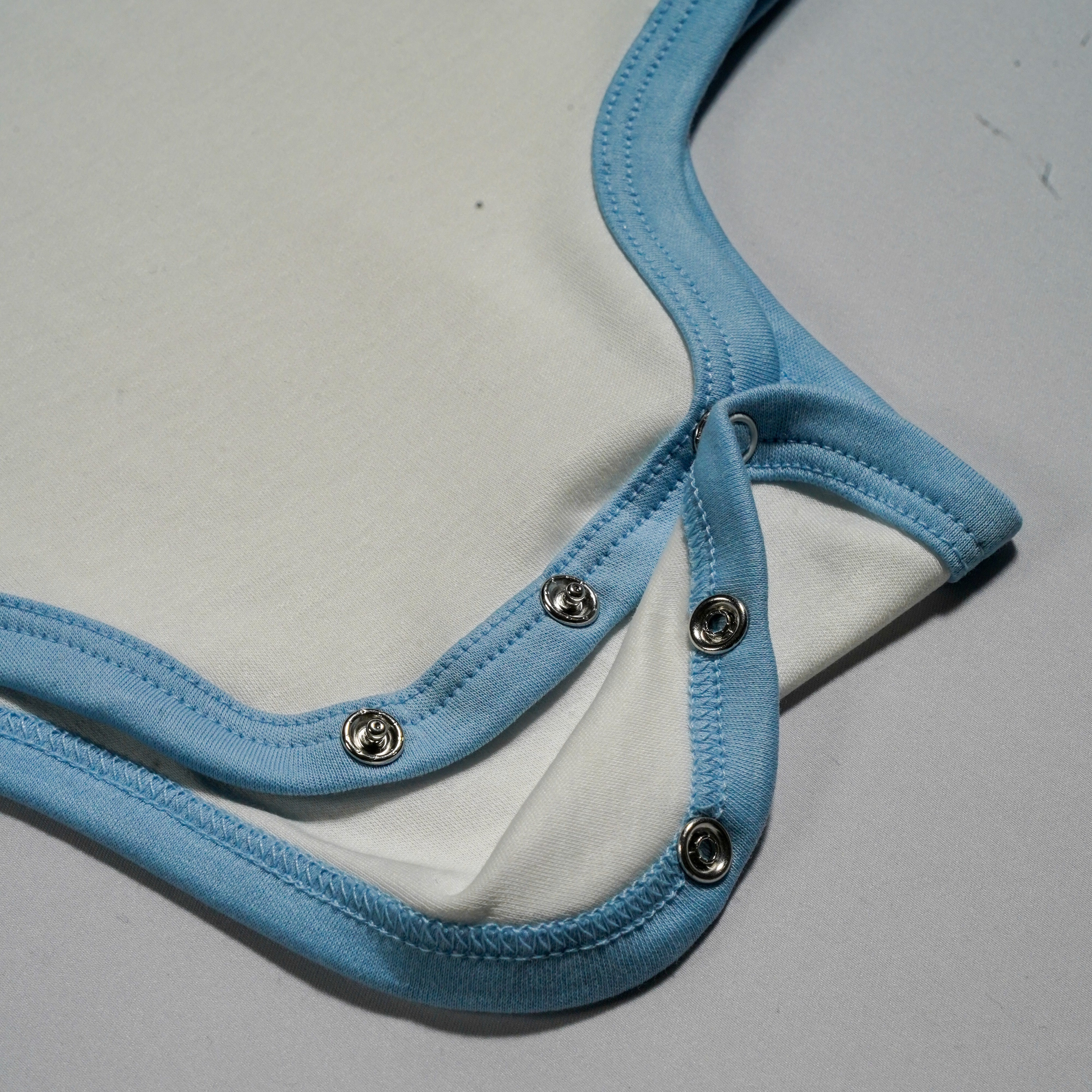 Long Sleeve Bodysuit In White With Chambray Blue