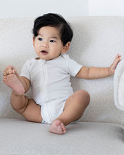 Short Sleeve Zipper Bodysuit In Pearl, 6-9m