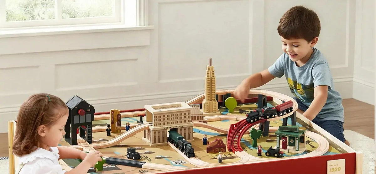 Two kids playing with a wooden train table