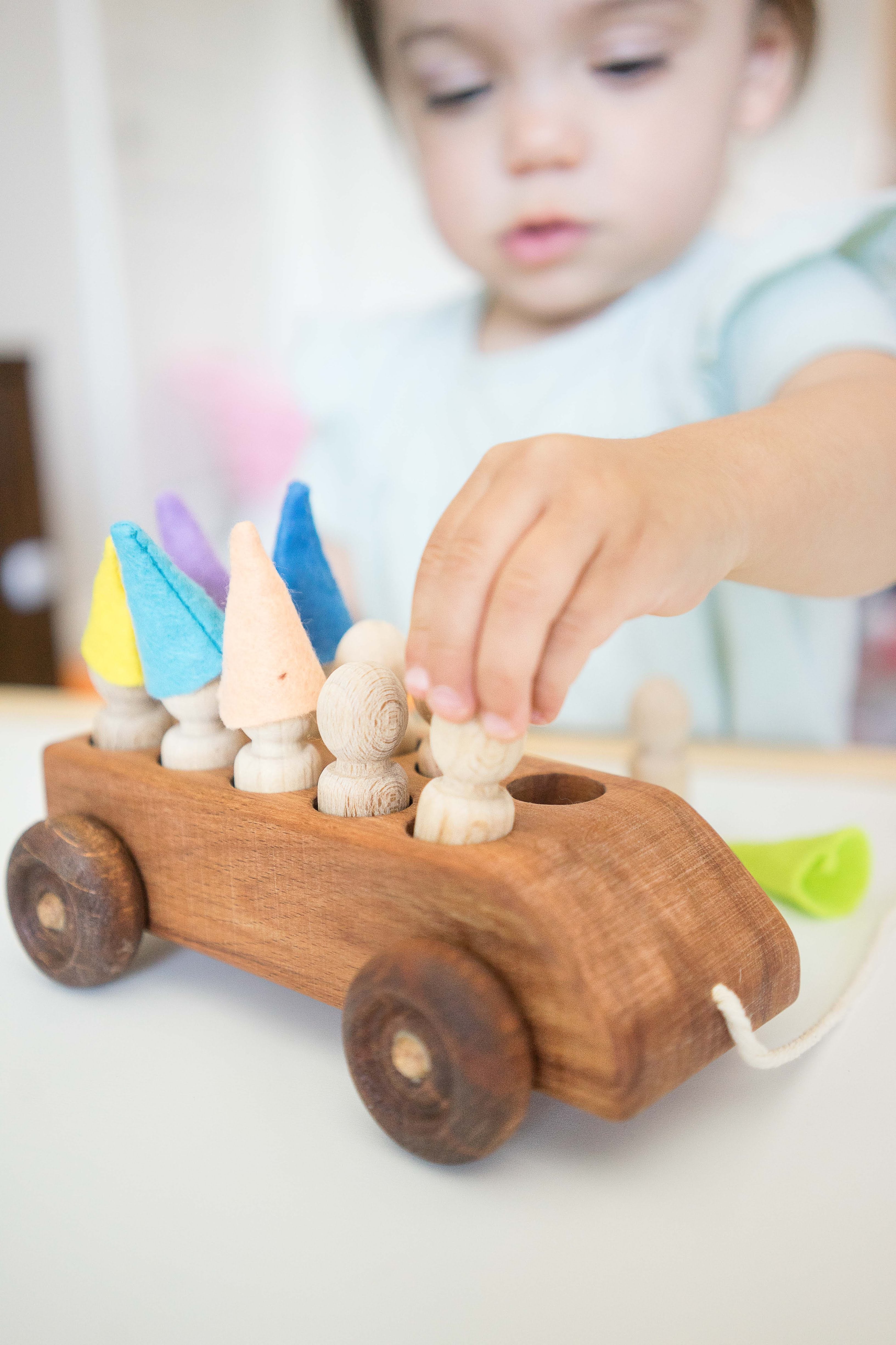 Wooden Toy Car With Ten Pegs In Multi-colored Hats