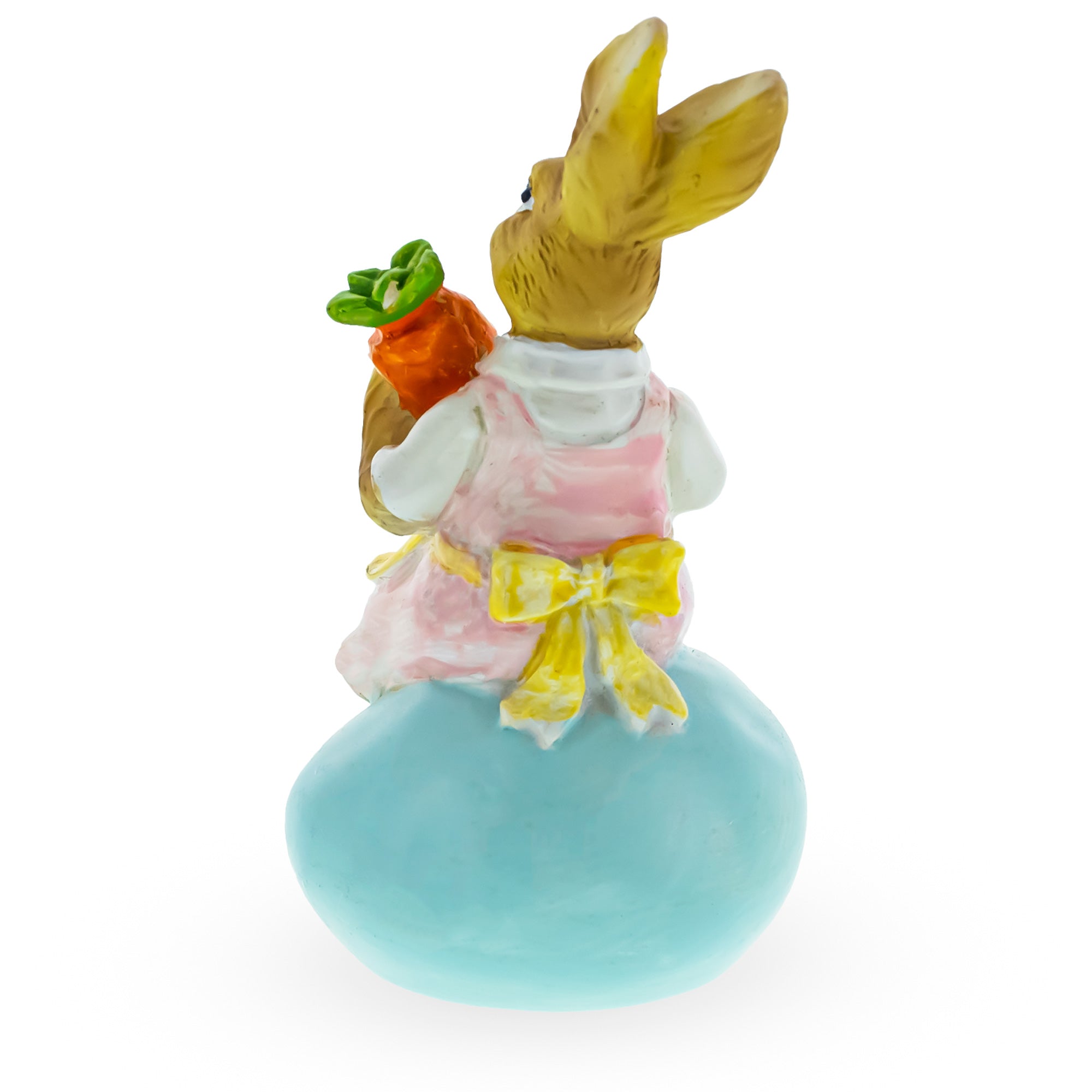 Springtime Serenity: Mother Bunny Cradling Carrot Atop A Decorative Easter Egg Figurine