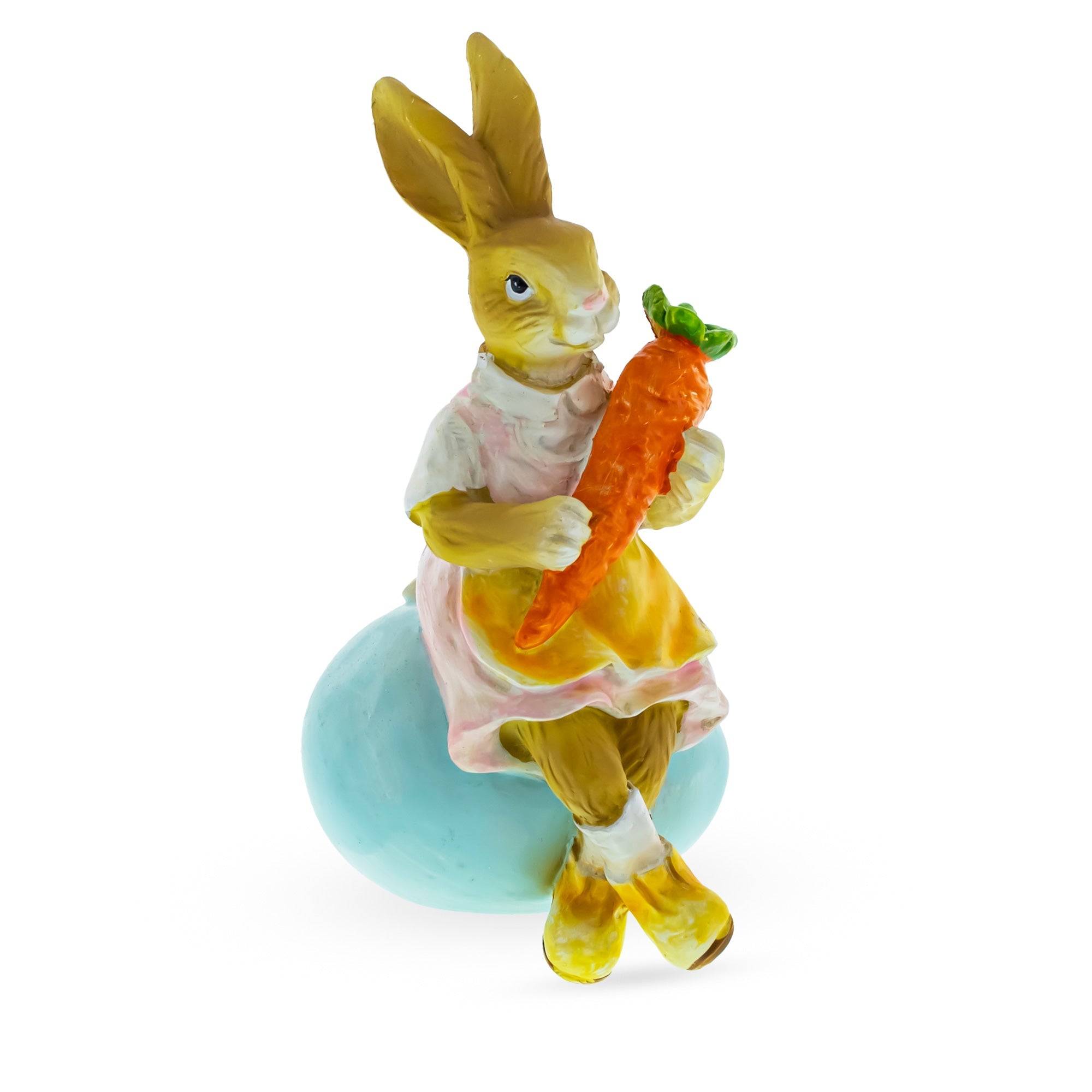 Springtime Serenity: Mother Bunny Cradling Carrot Atop A Decorative Easter Egg Figurine